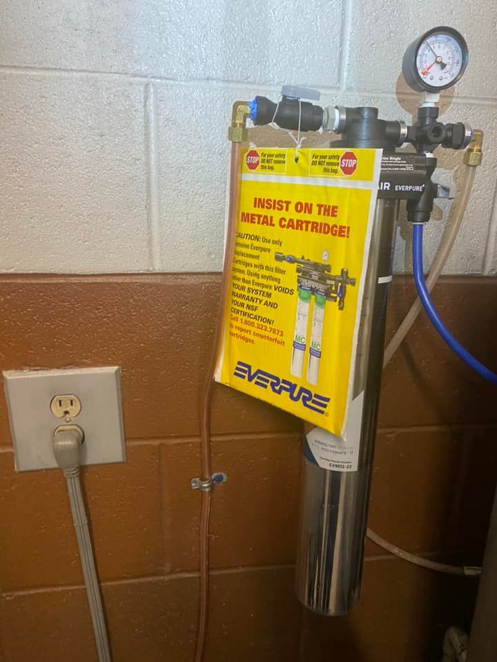 A stainless steel water filter with a pamphlet attached to it