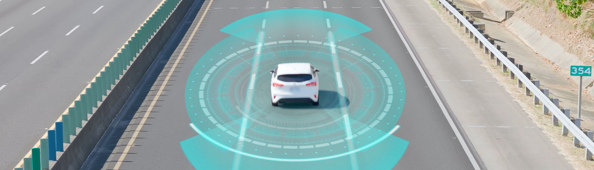 A white car driving on a highway, with blue semi-circle radar visualizations, in an urban setting.
