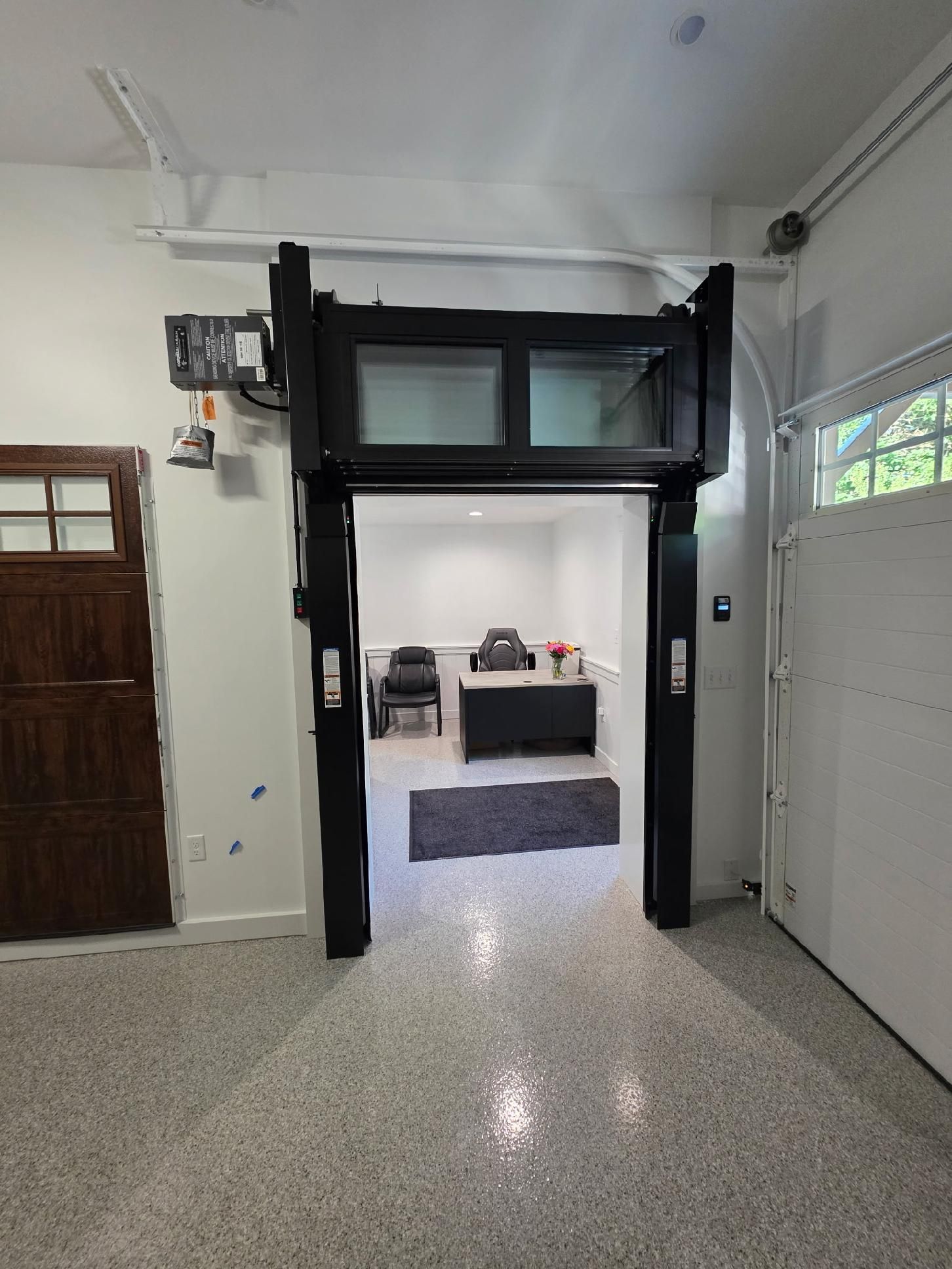 Interior showroom with garage door styles on display.