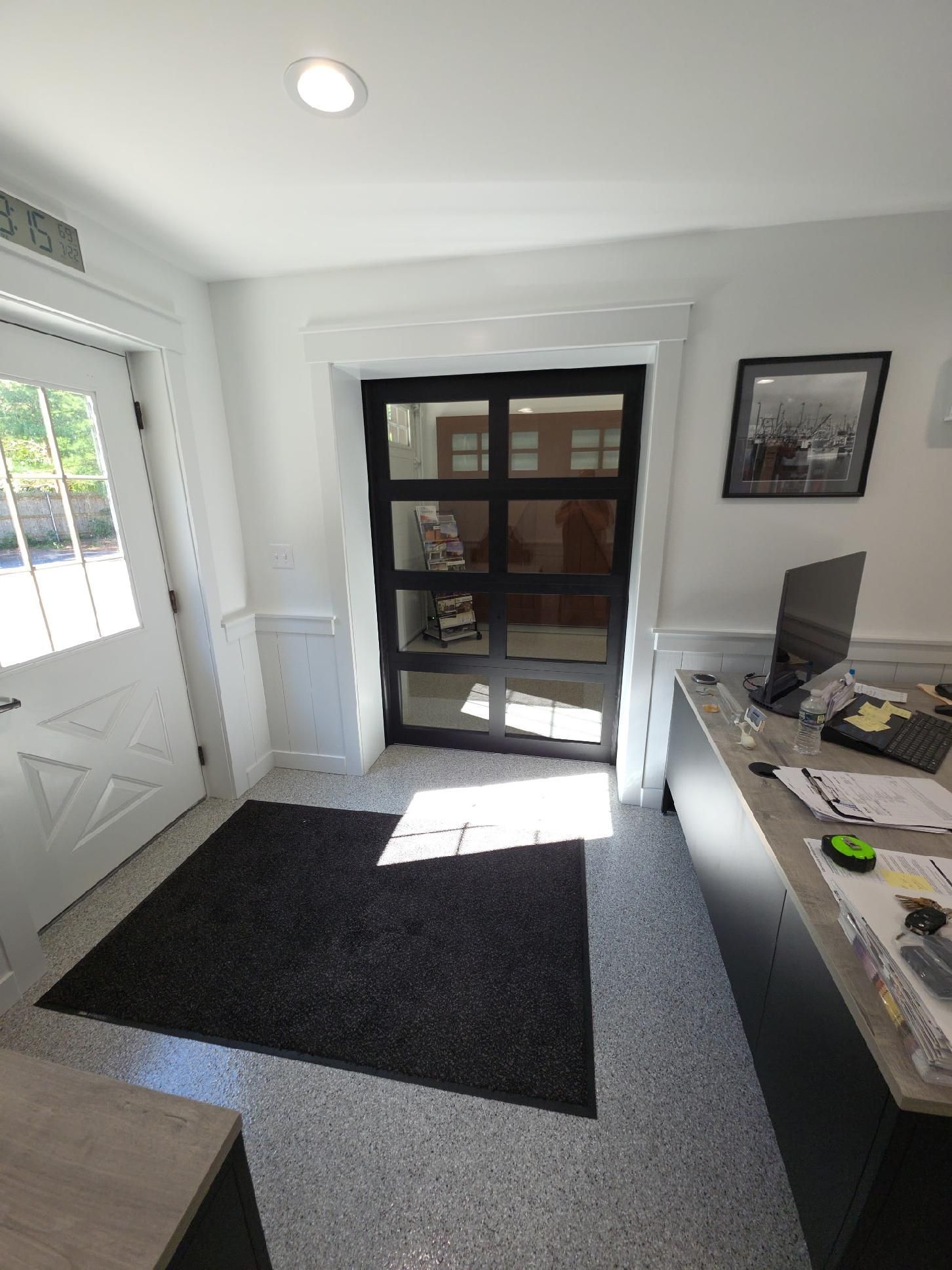 Interior showroom with various garage door styles on display.