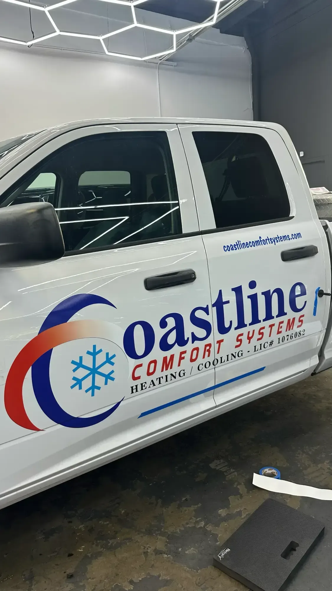 White truck with Coastline Comfort Systems logo on the side.