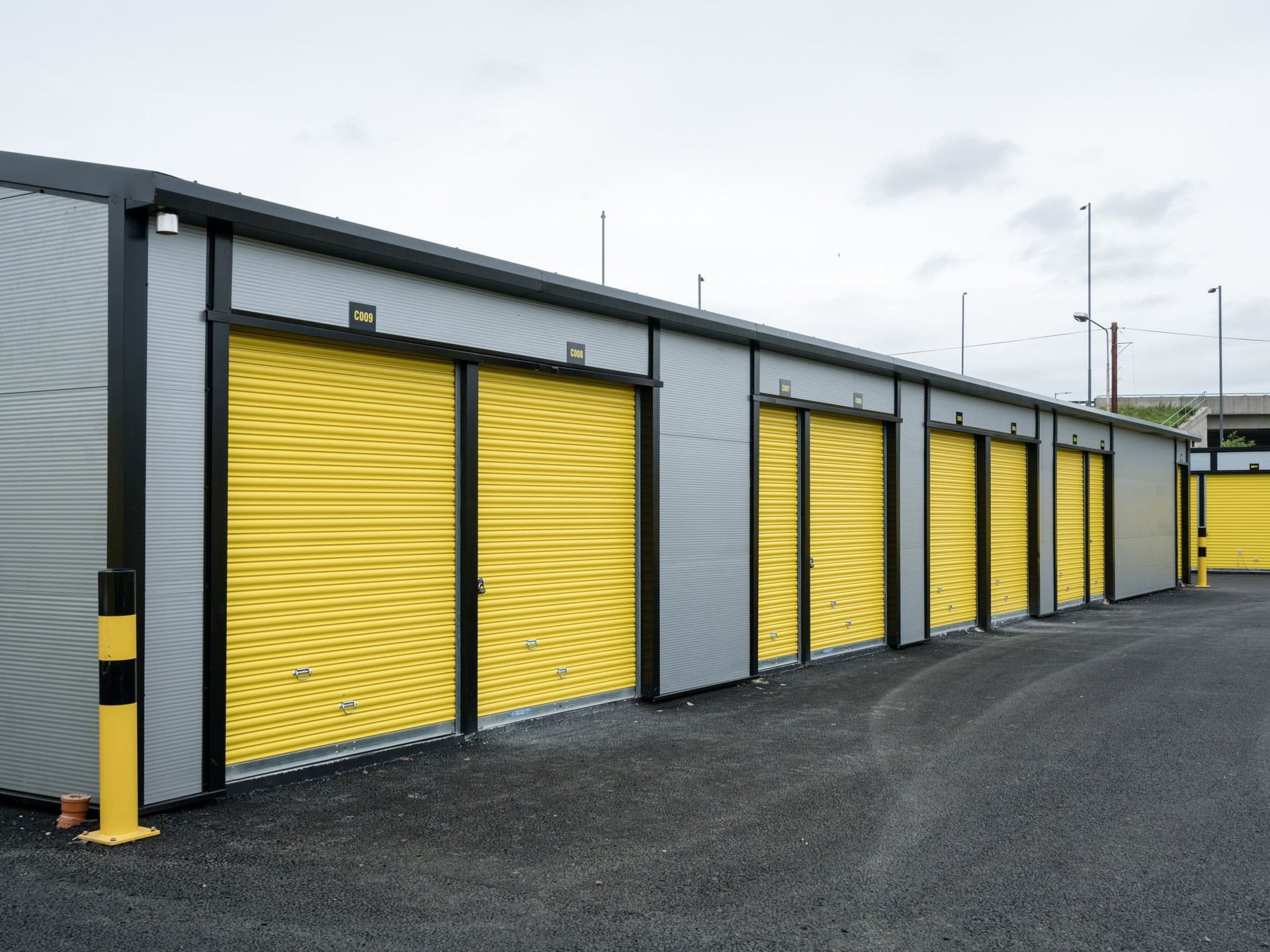 A row of storage units with yellow doors