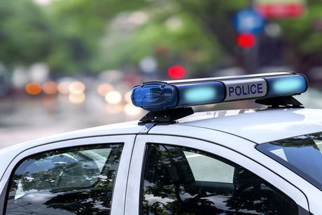 A police car with a blue light on top of it.