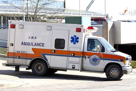 An ambulance is parked on the side of the road