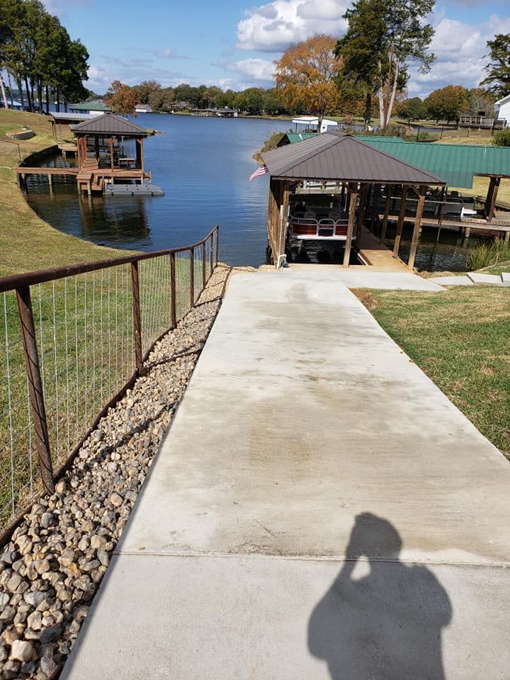 a concrete walkway leads to a dock with a boat in it