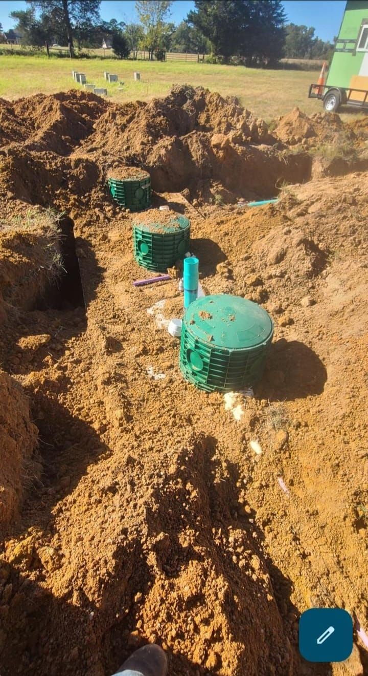 a large pile of dirt with a green container in the middle