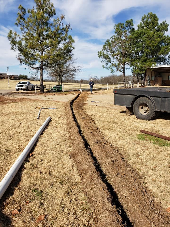 a tow truck is parked on the side of a dirt road