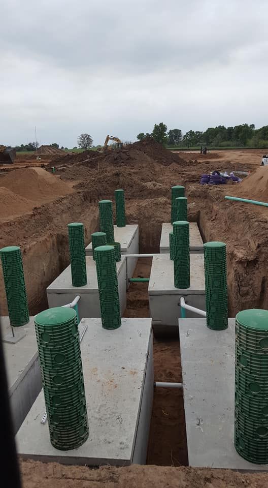 a construction site with a lot of green pipes