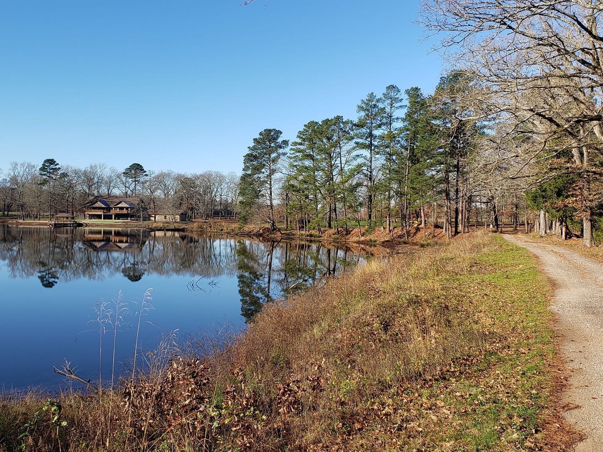 a house sits on the shore of a lake
