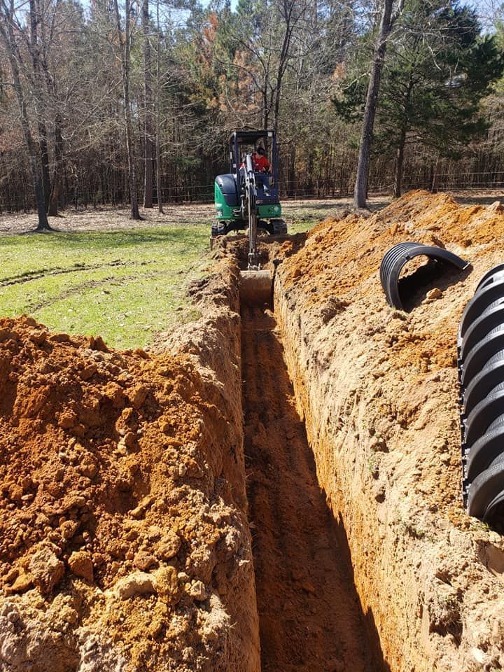a tractor is digging a trench in the dirt