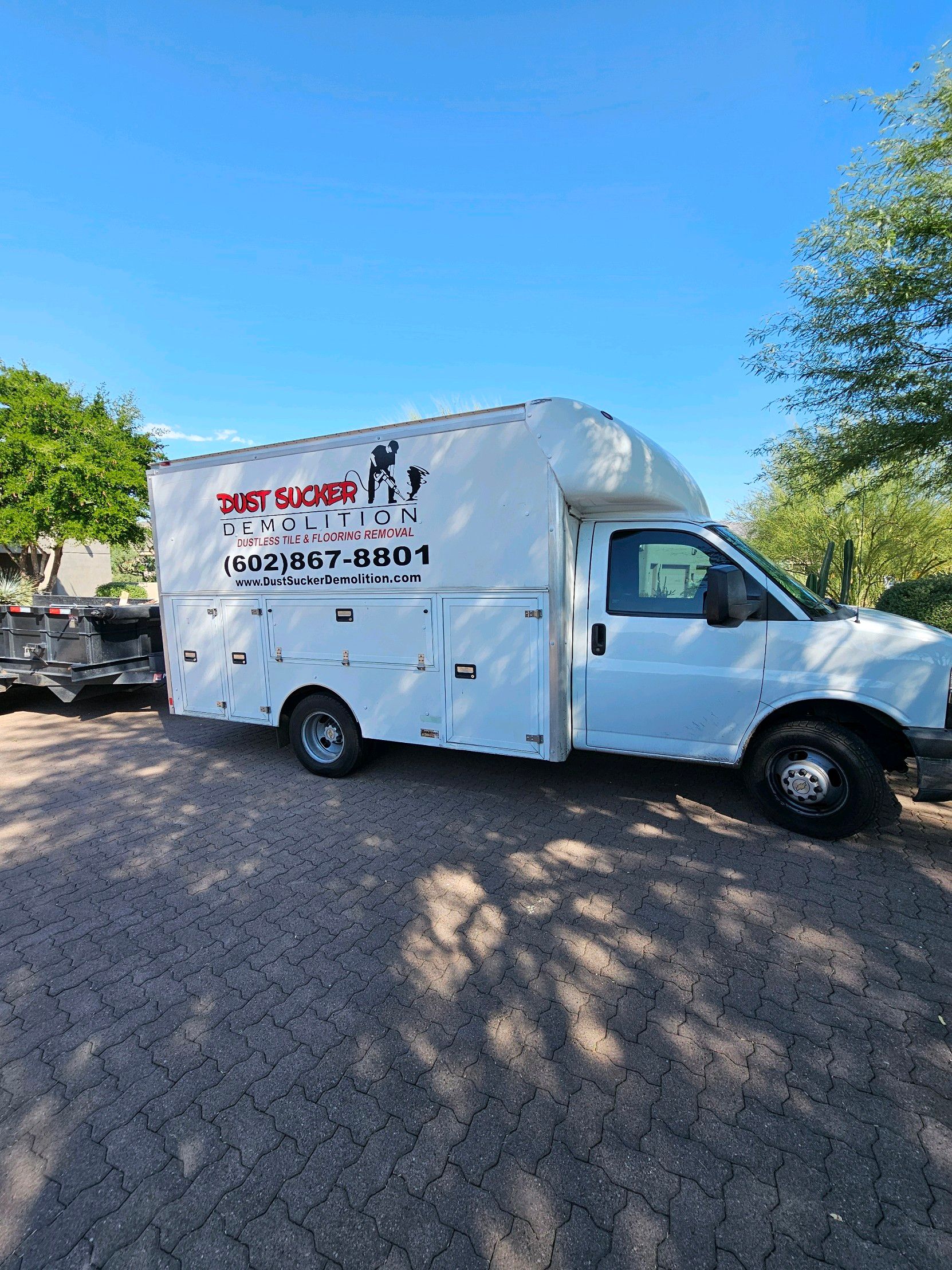 A white truck is parked in a parking lot.
