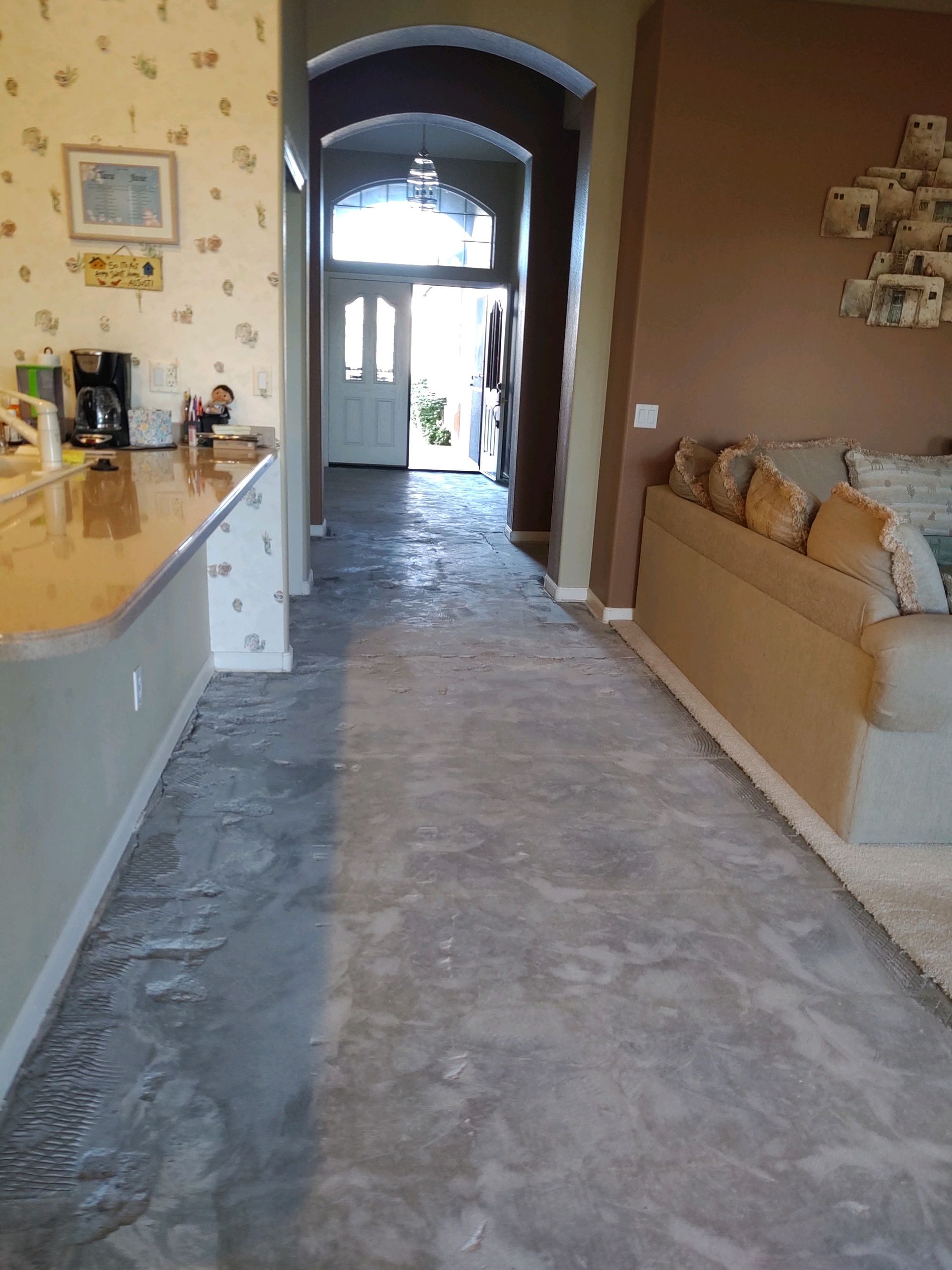 A hallway in a house with a couch and a table