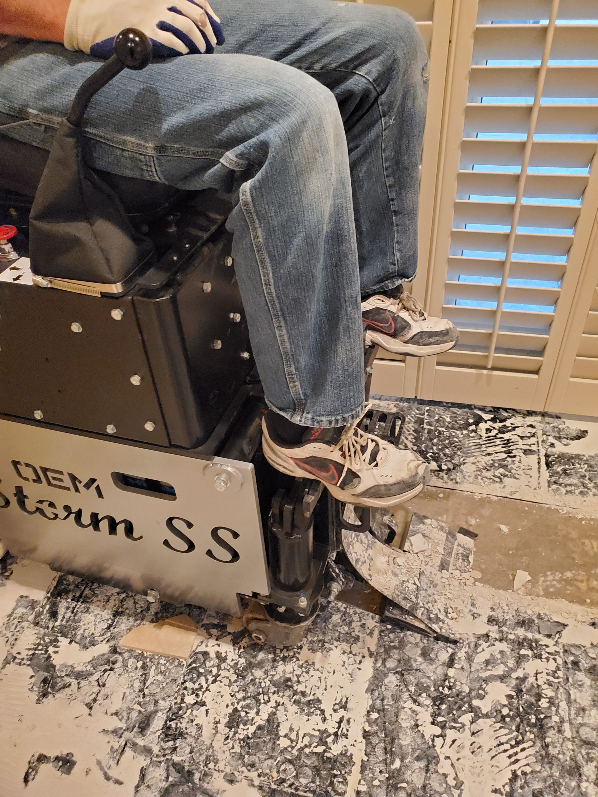 A man is sitting on a box with his legs crossed.