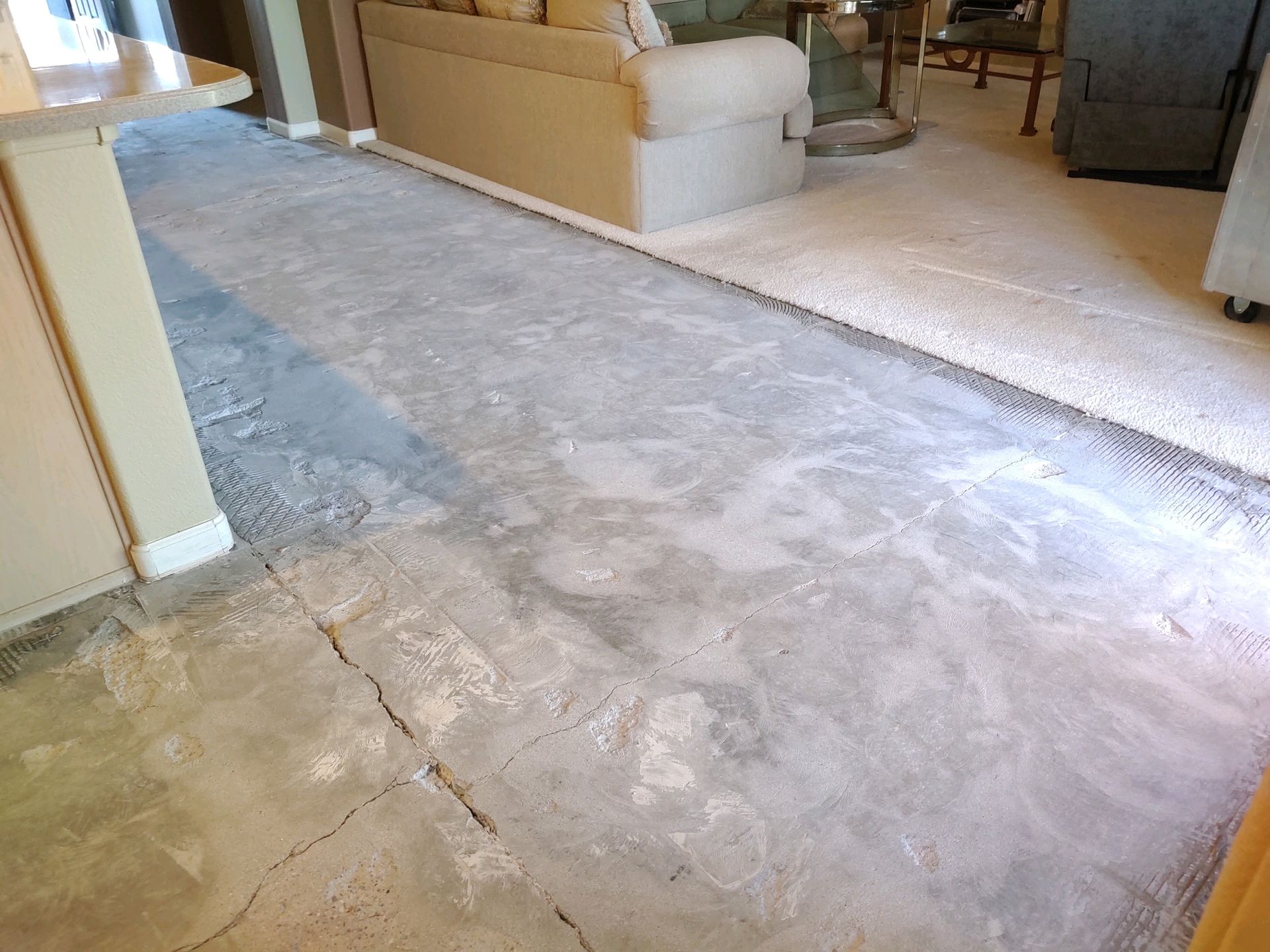 A living room with a concrete floor and a couch.