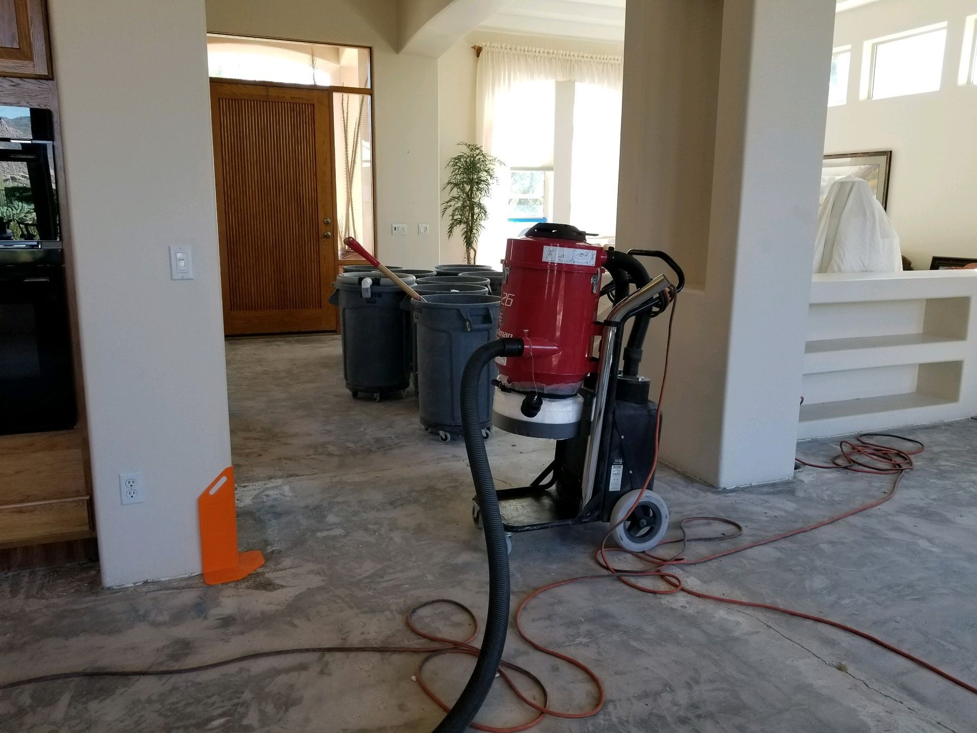 A vacuum cleaner is sitting on the floor in a room.