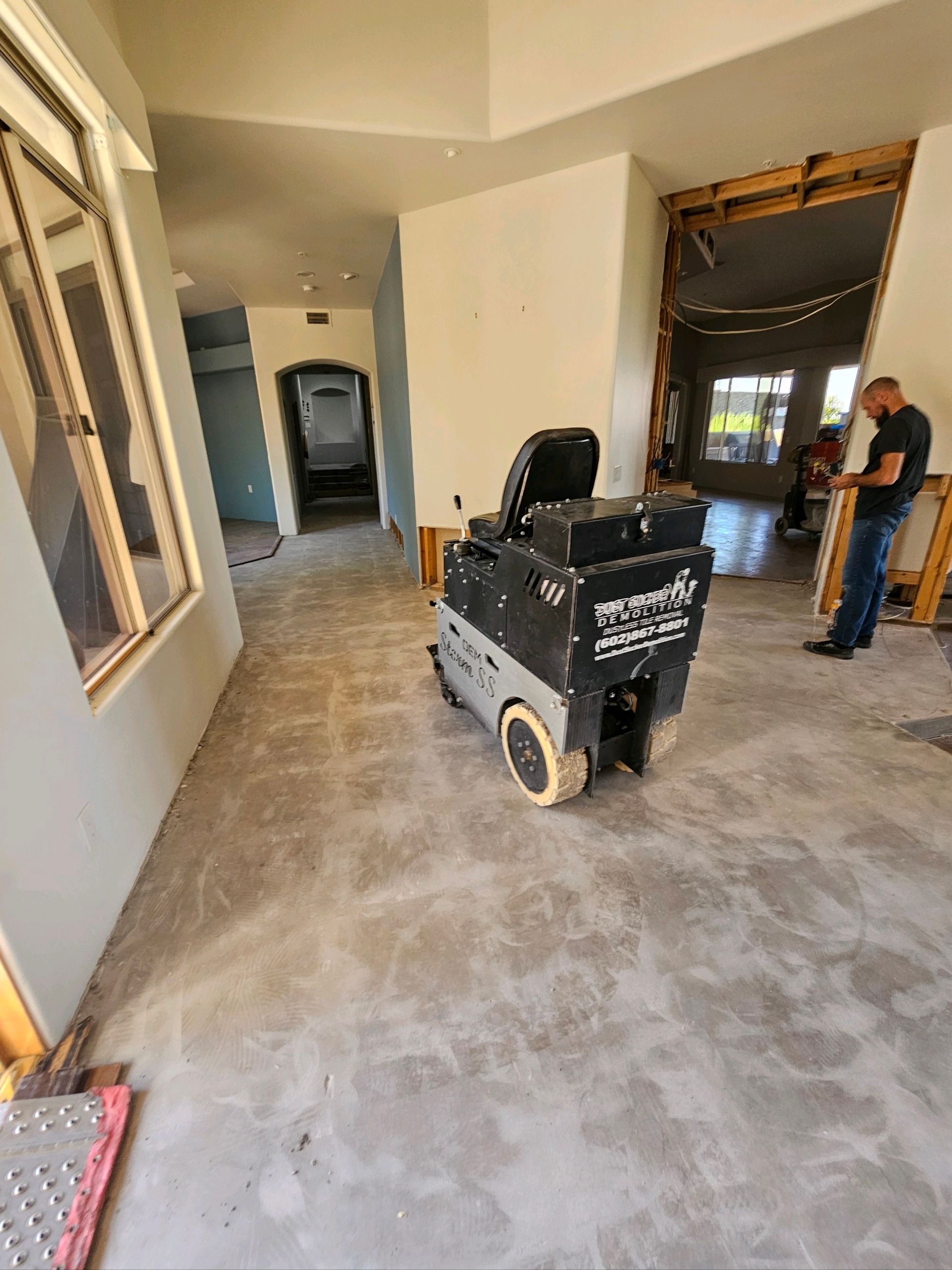 A man is standing next to a machine in a room.