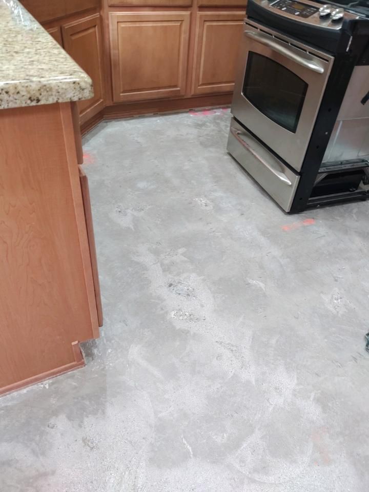 A kitchen with a stove and oven on the floor.