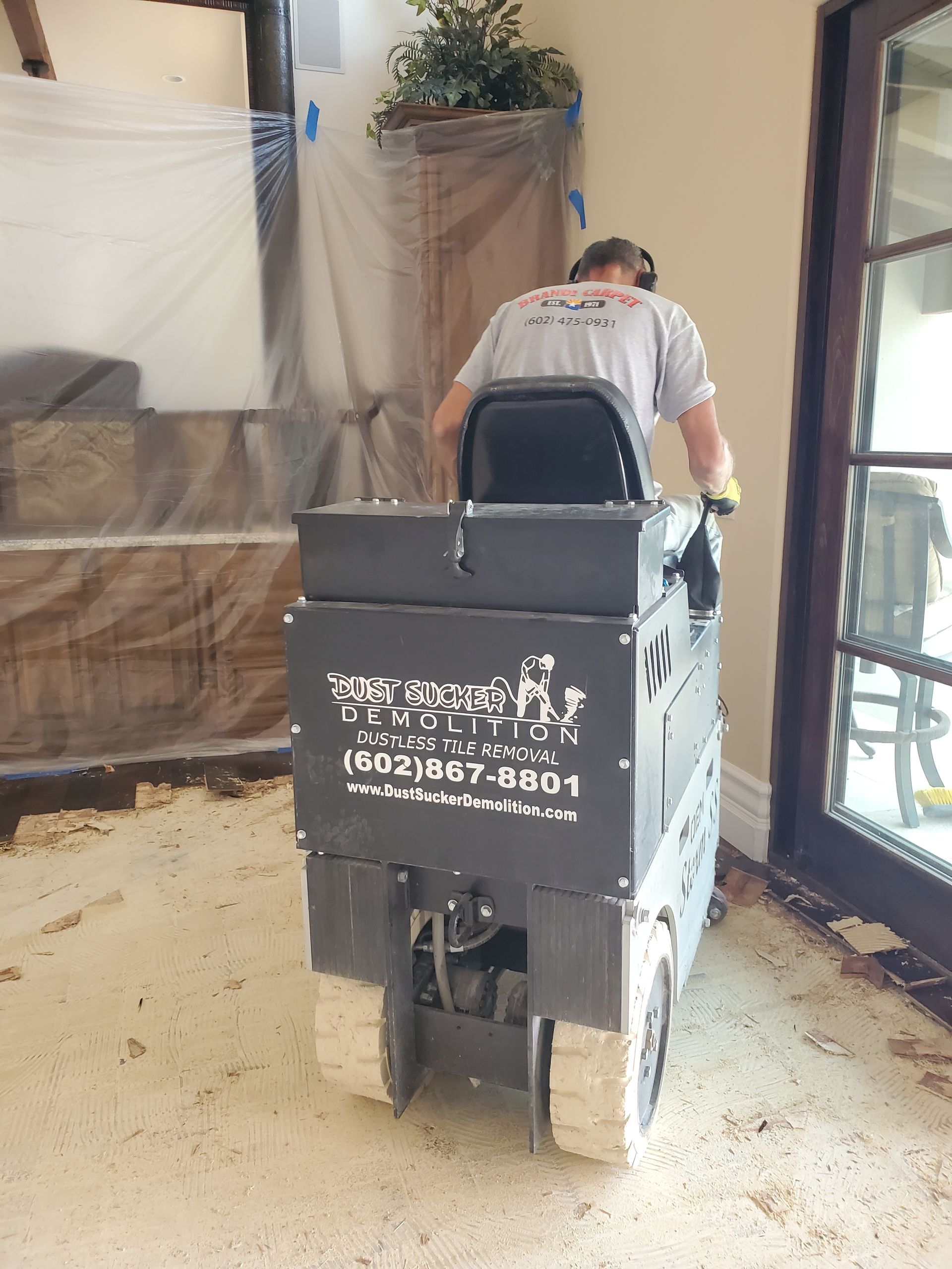 A man is riding a machine that says carpet fix on the back.