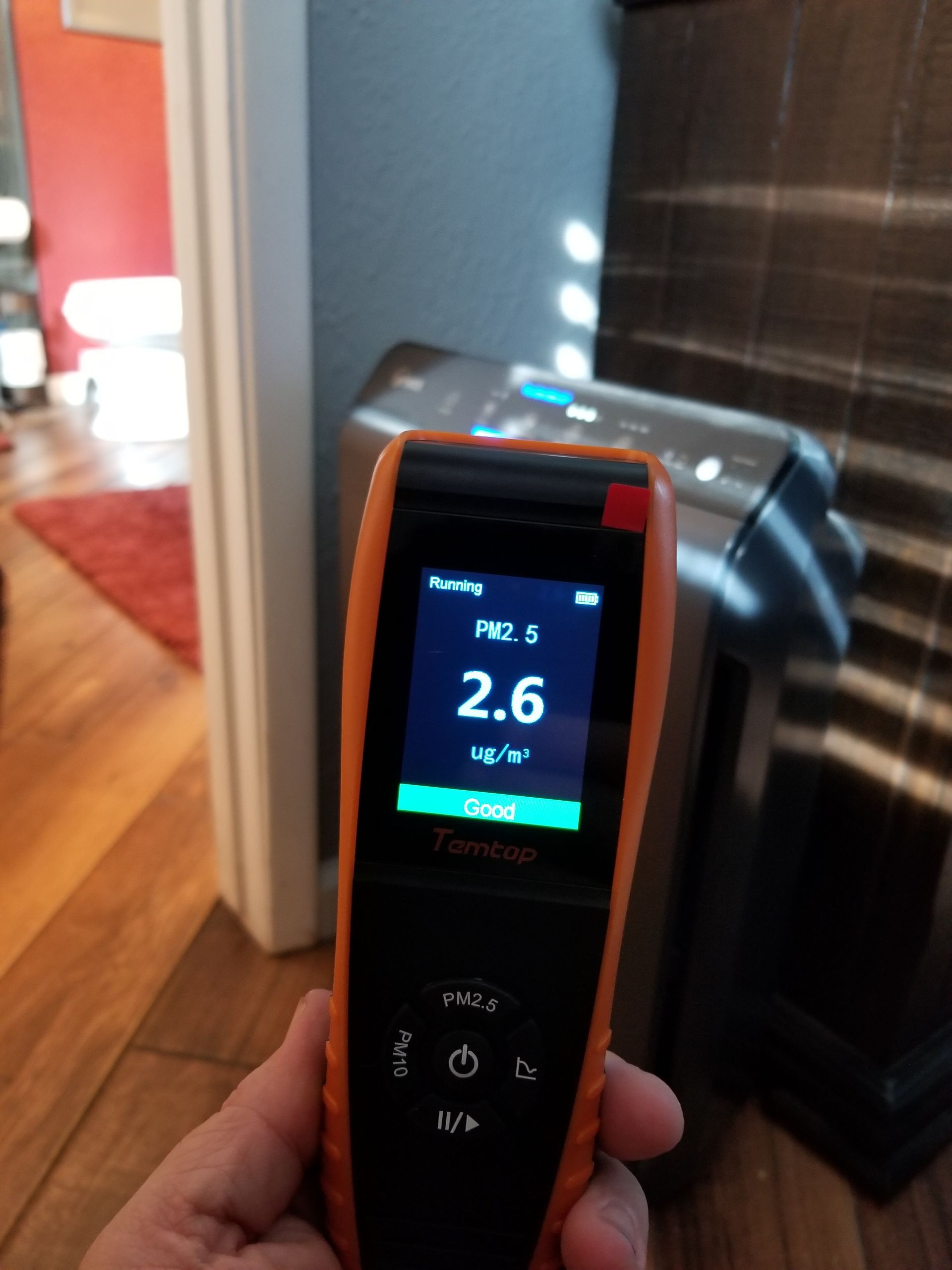 A person is holding a device that says 2.6 on the screen