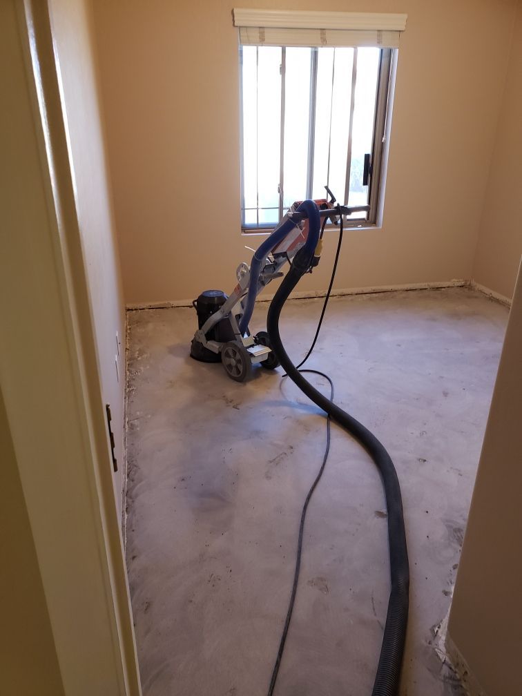 A vacuum cleaner is sitting in a room next to a window.