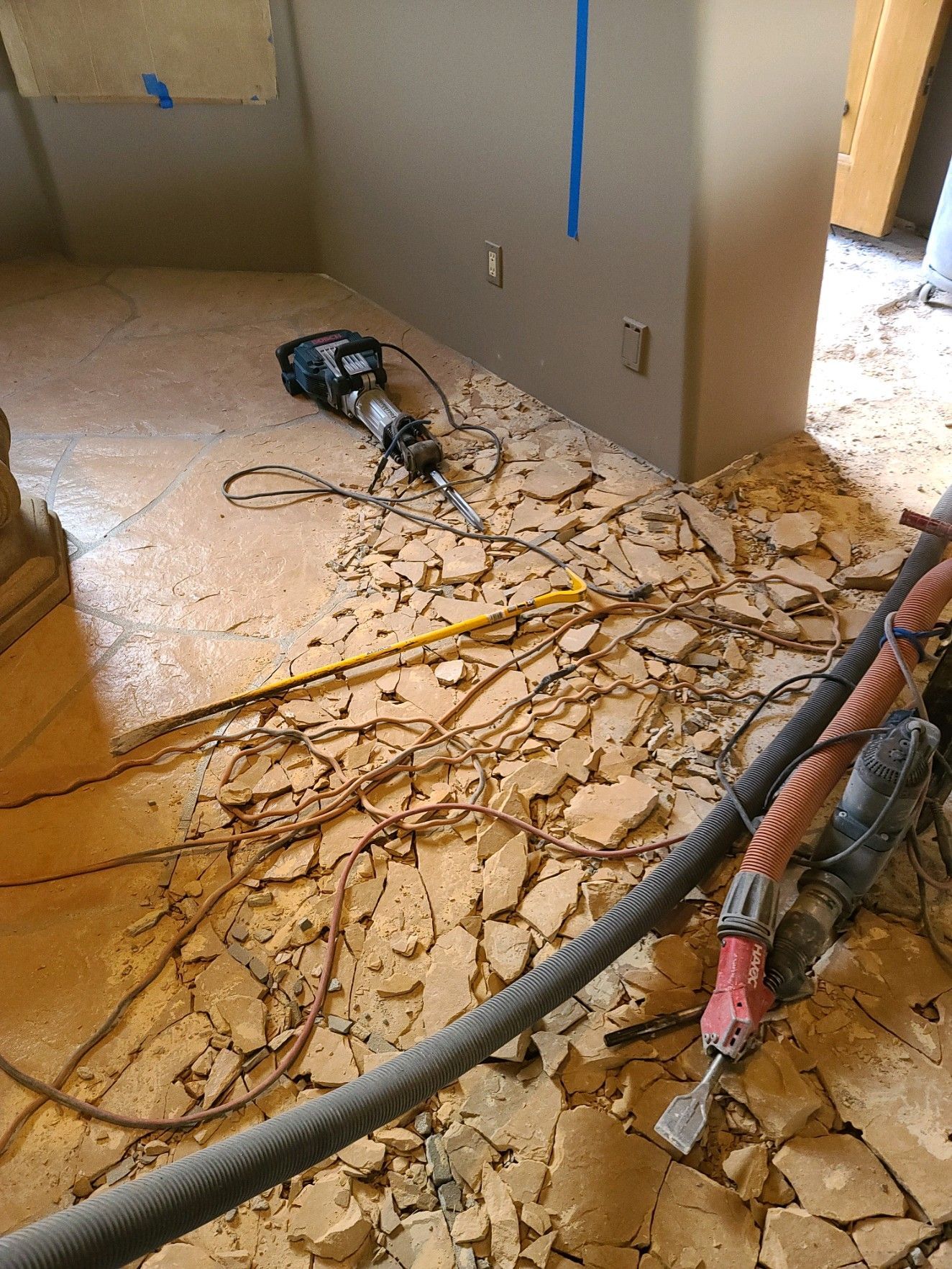 A hammer is laying on the floor of a room.