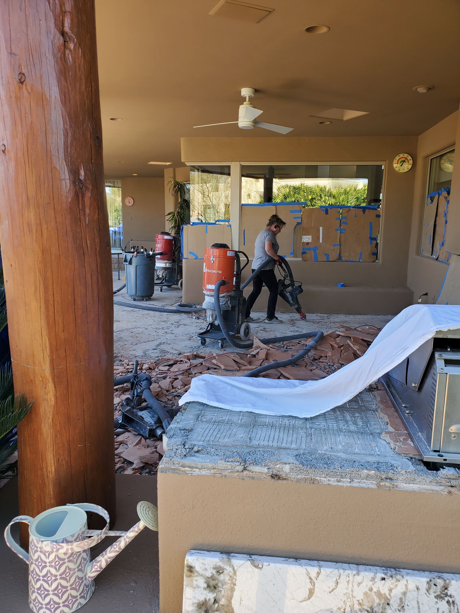 A man is using a vacuum cleaner to clean the floor of a house.