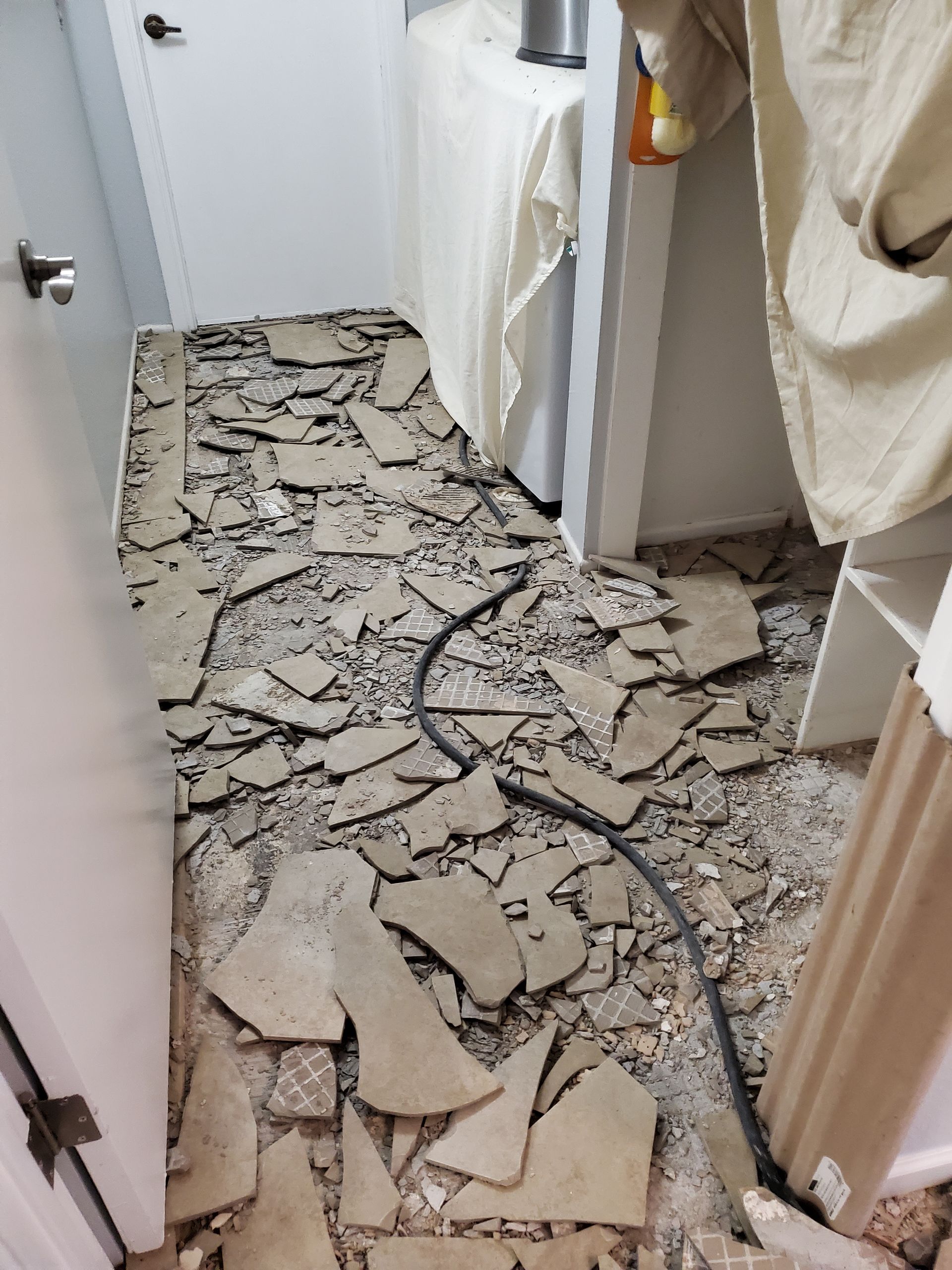 A room with a lot of broken tiles on the floor