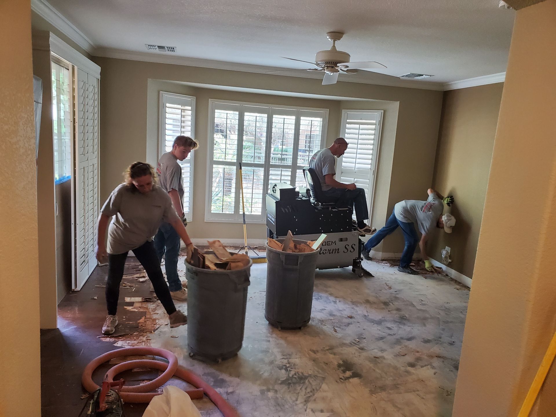 A group of people are working in a living room.