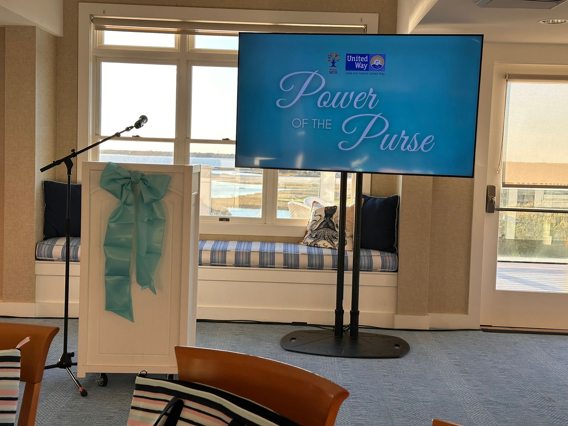 Podium with microphone, a large screen displaying 