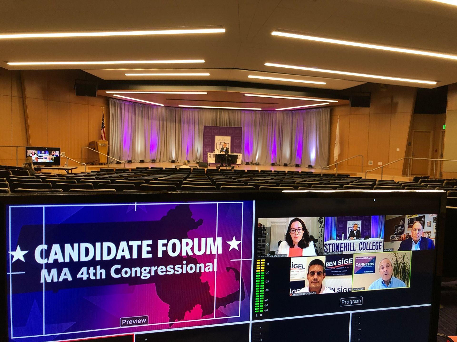 Candidate forum, Massachusetts 4th Congressional District. Virtual event with panelists on screens; auditorium setting.