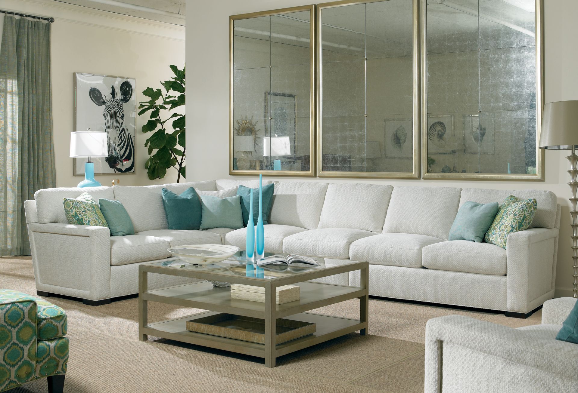 A living room with white furniture and a coffee table