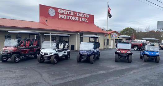 Several golf carts parked in front of Smith-Davis Motors Inc. building.