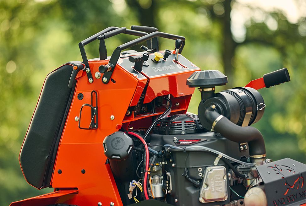 Orange and black commercial lawn mower engine.