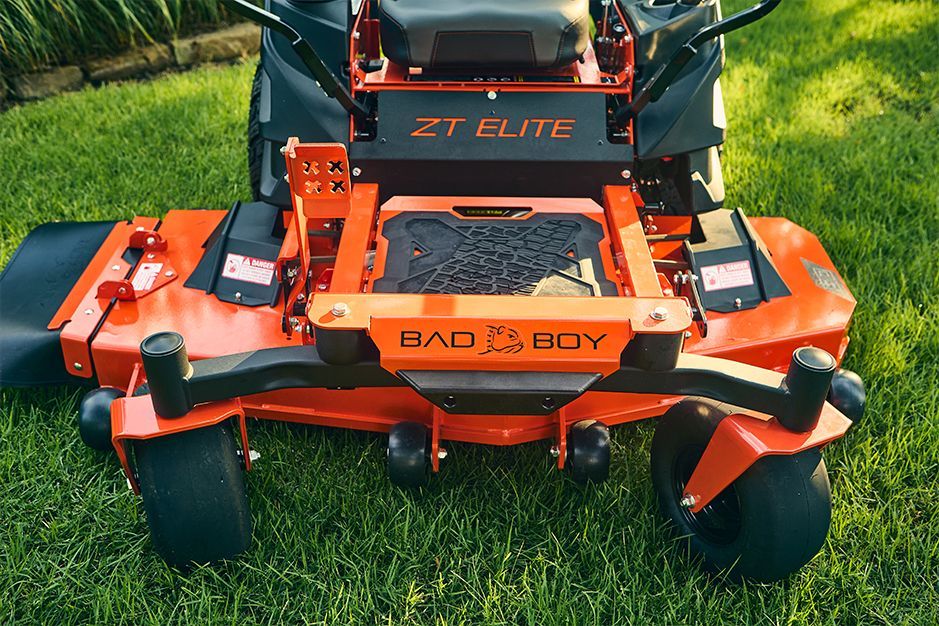 Orange Bad Boy ZT Elite zero-turn mower on green grass.