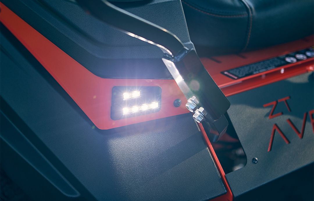 Bright LED lights on the side of a red and black vehicle. The logo 