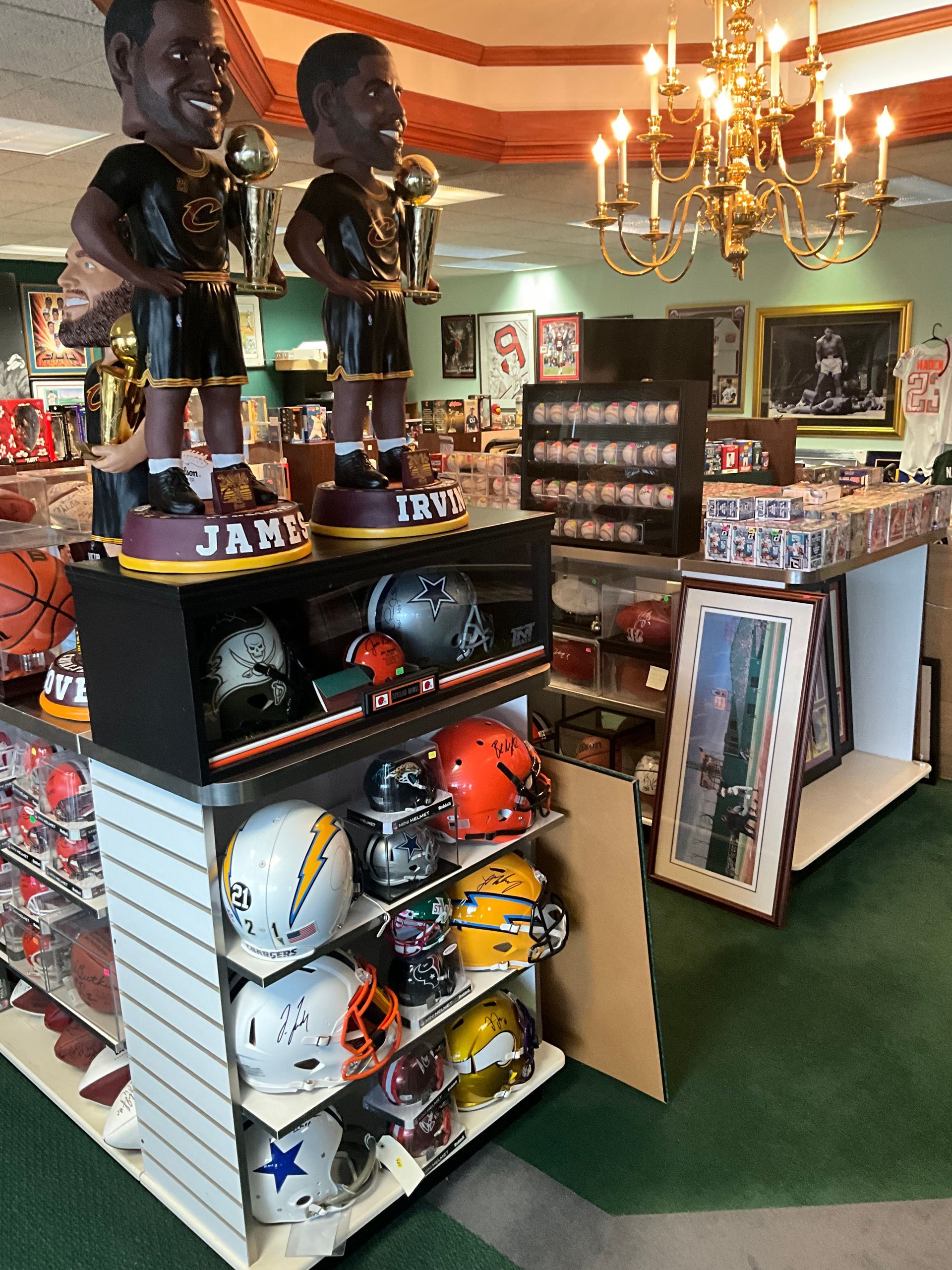 Sports memorabilia store with bobbleheads, helmets, and framed items on display.