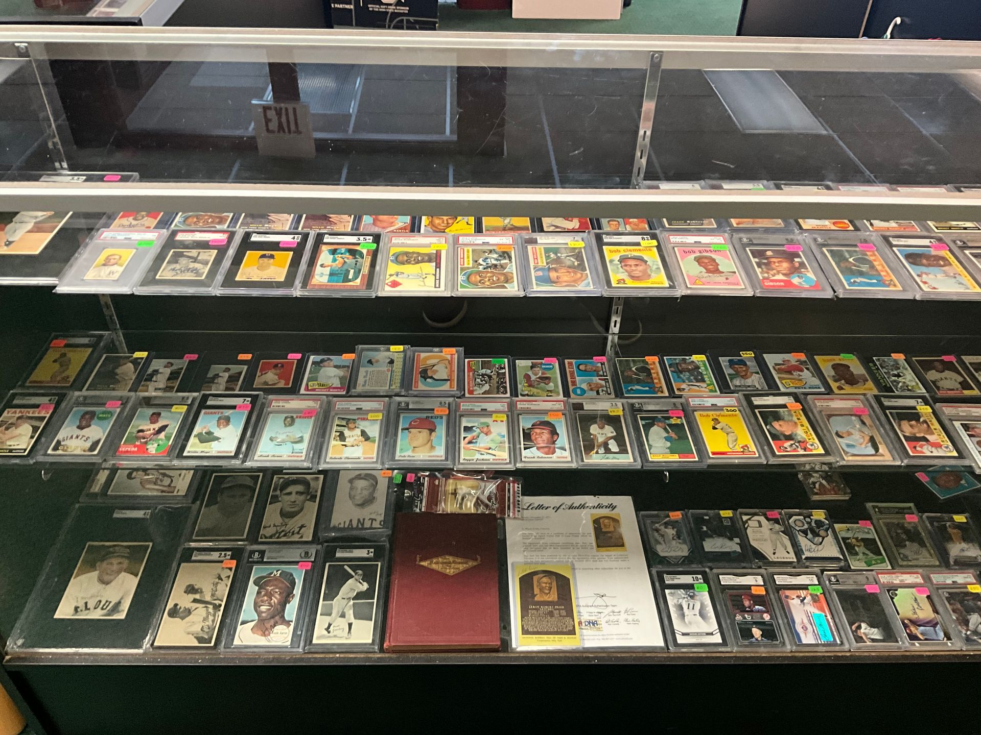 A display case filled with graded baseball cards. 