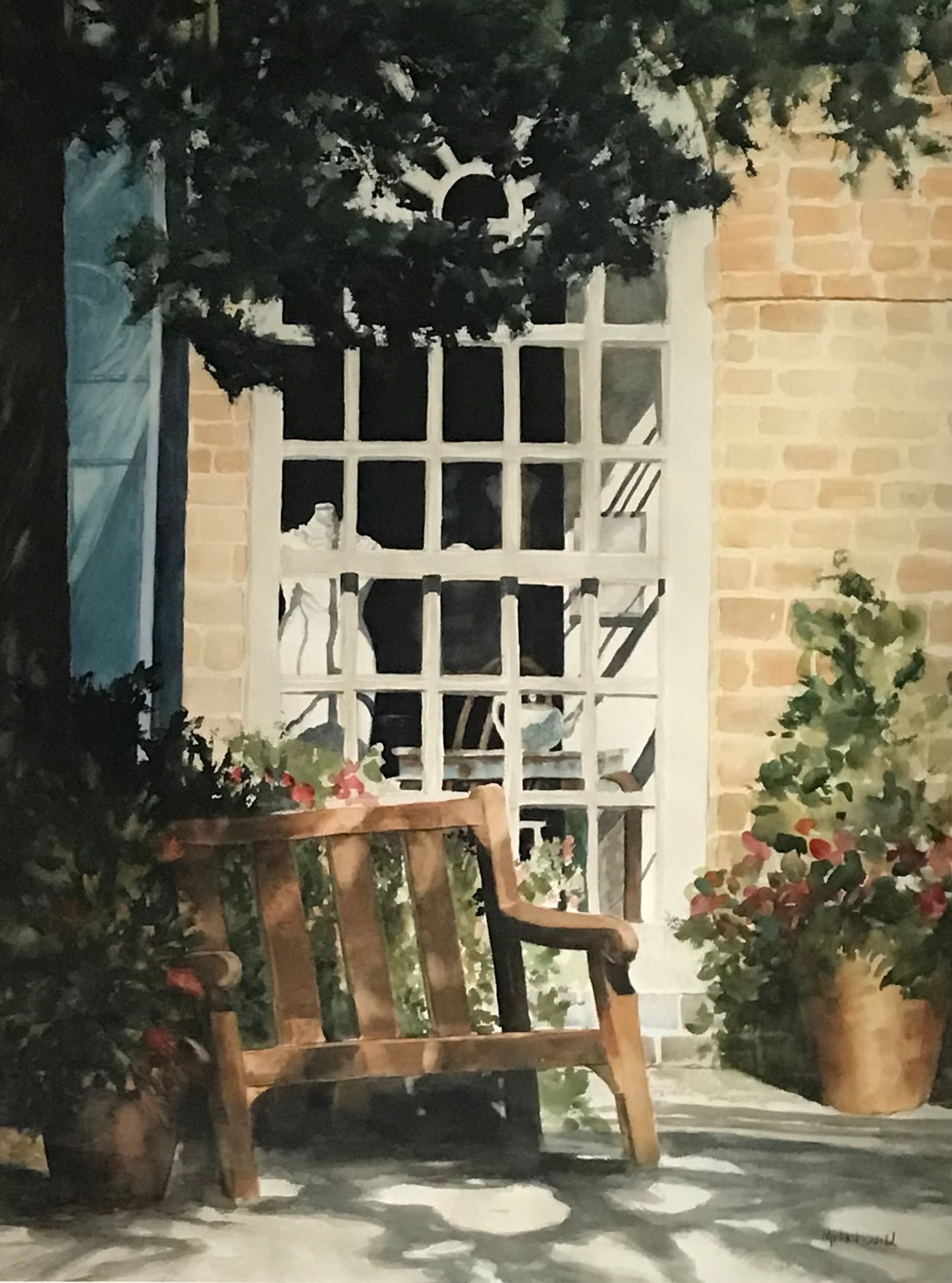 a wooden rocking chair sits in front of a brick building