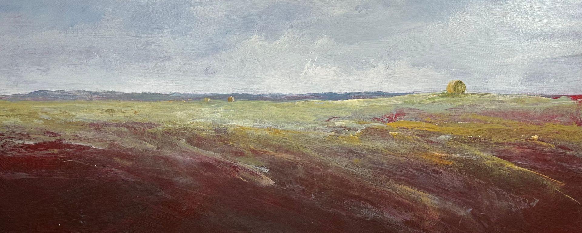 It is a painting of a field with trees in the distance.