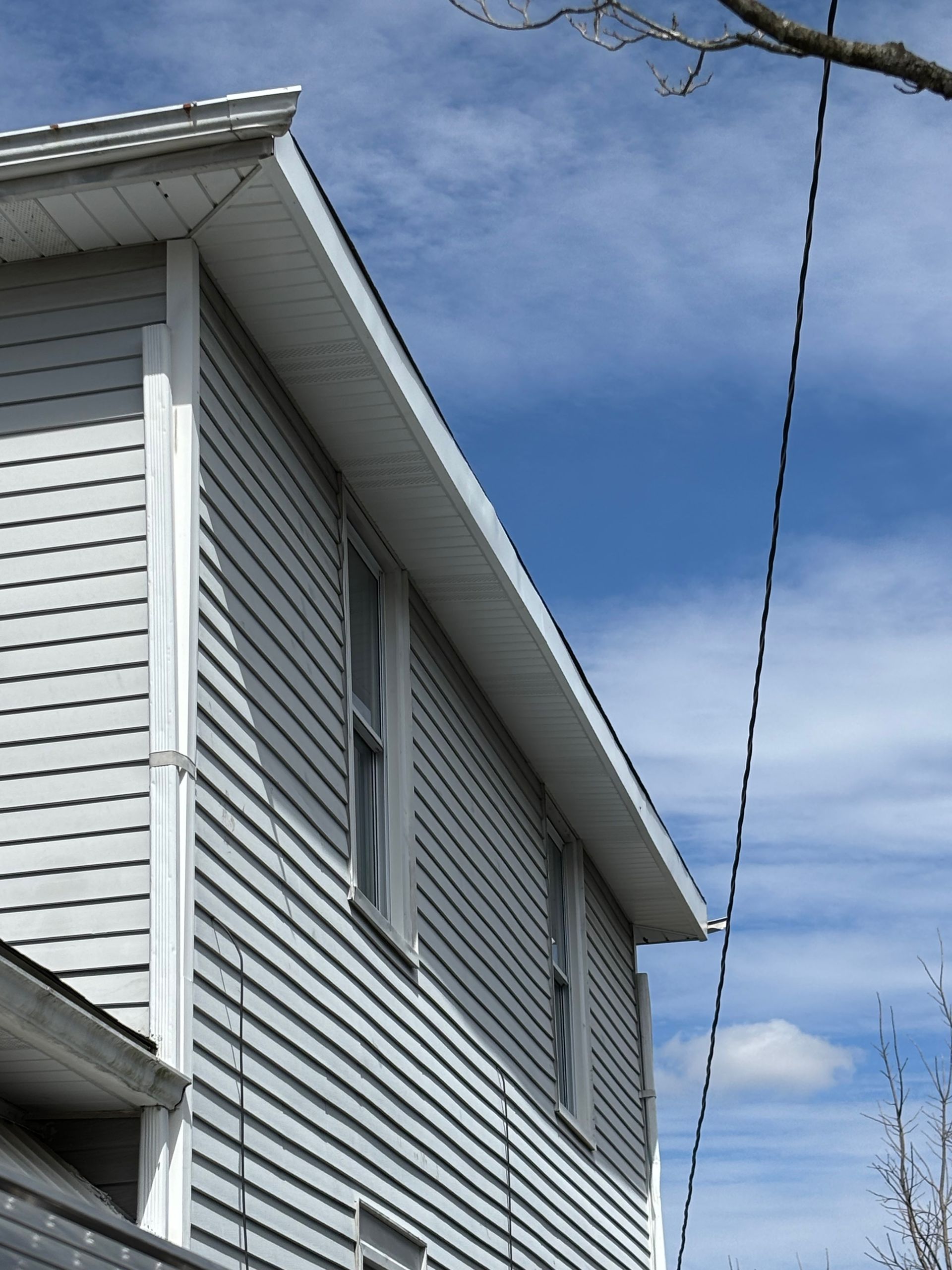 A white house with a blue sky in the background