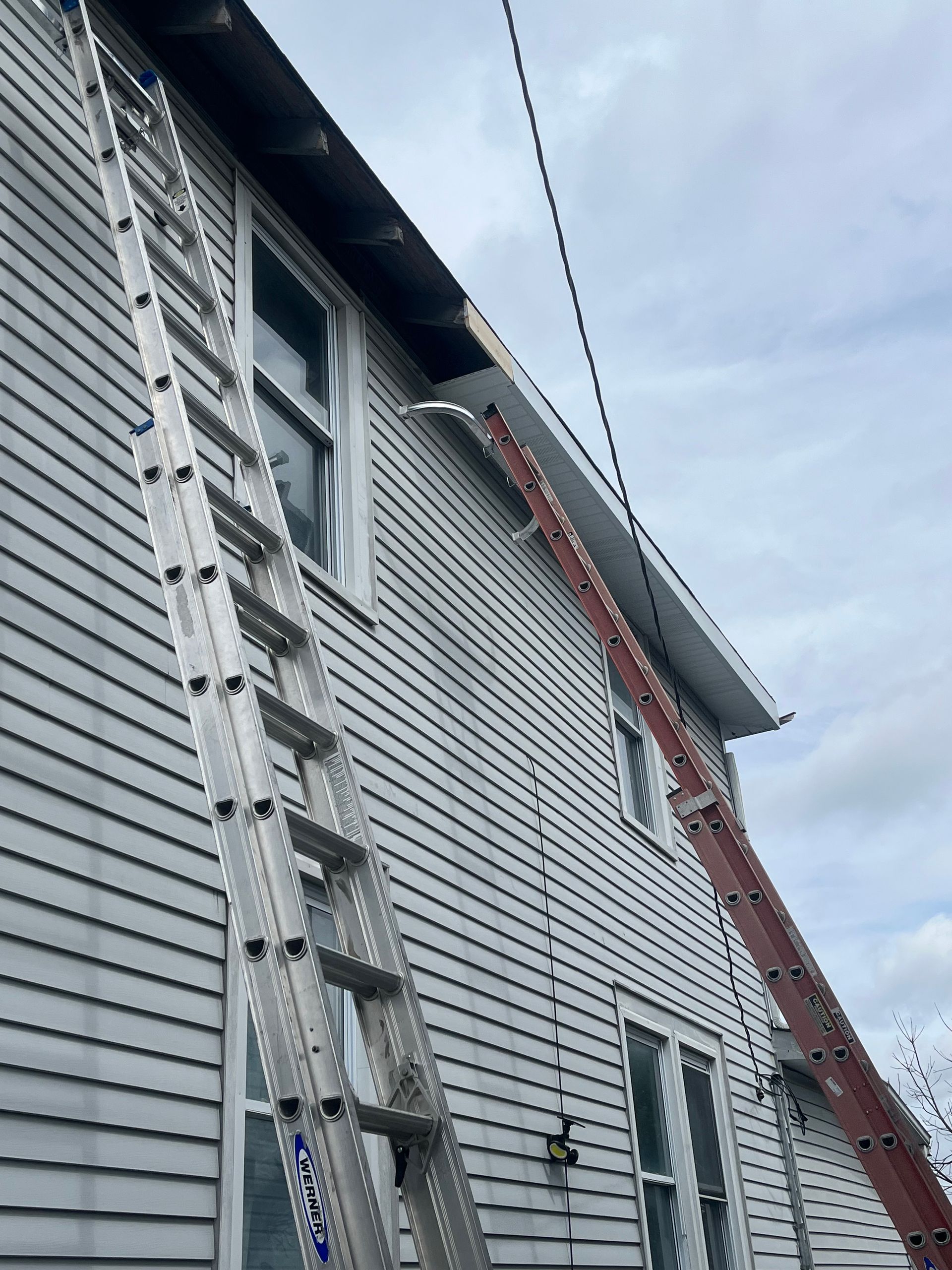 A ladder is attached to the side of a house.