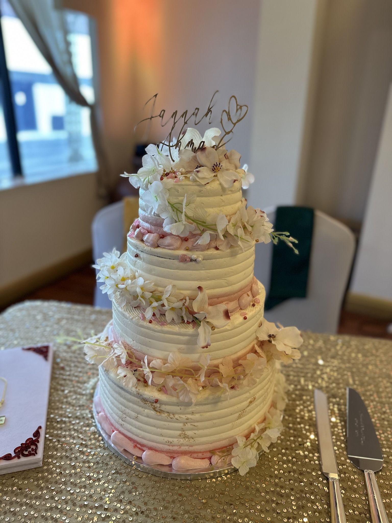 A wedding cake is sitting on top of a table.