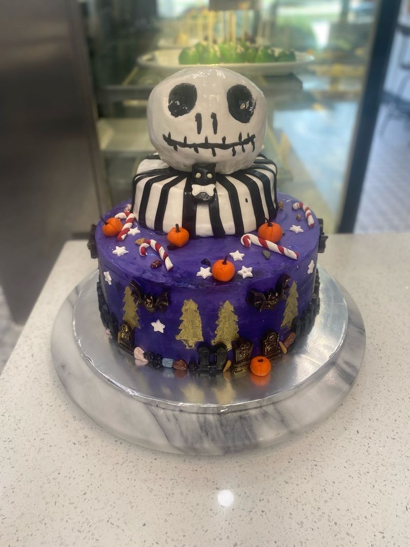 A nightmare before christmas cake with a skeleton on top of it.