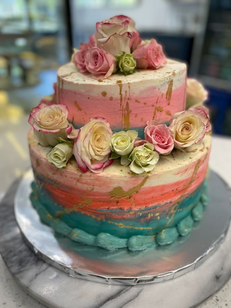 A two tiered cake with pumpkins and a one sign on top of it.