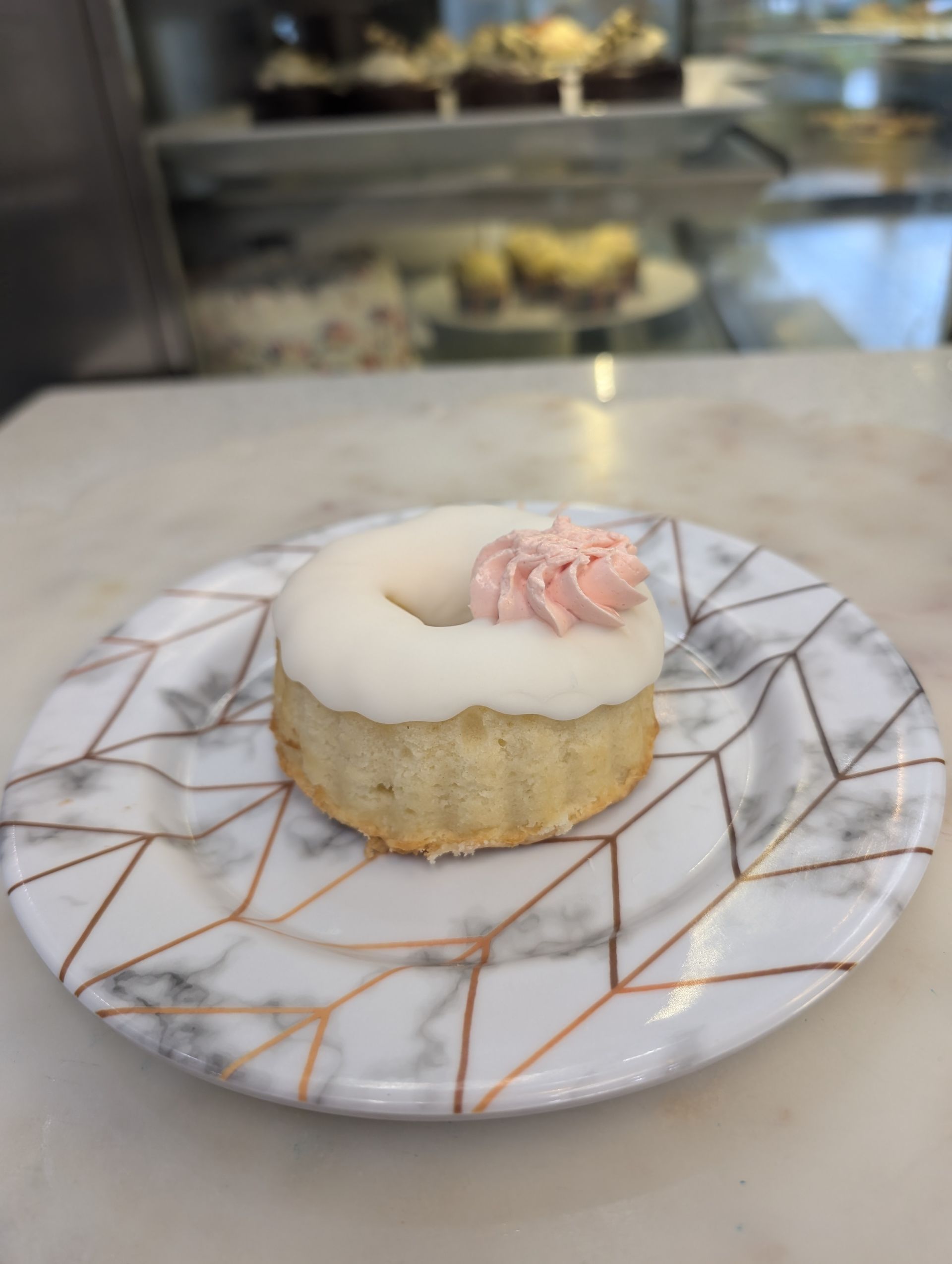 A marble plate with a donut on it
