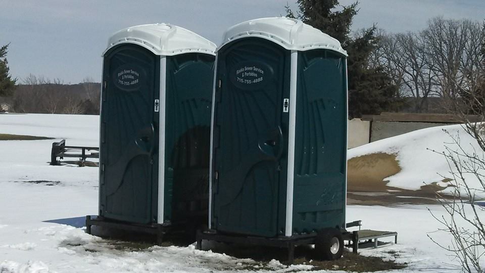portable toilets set up outside in a winter season