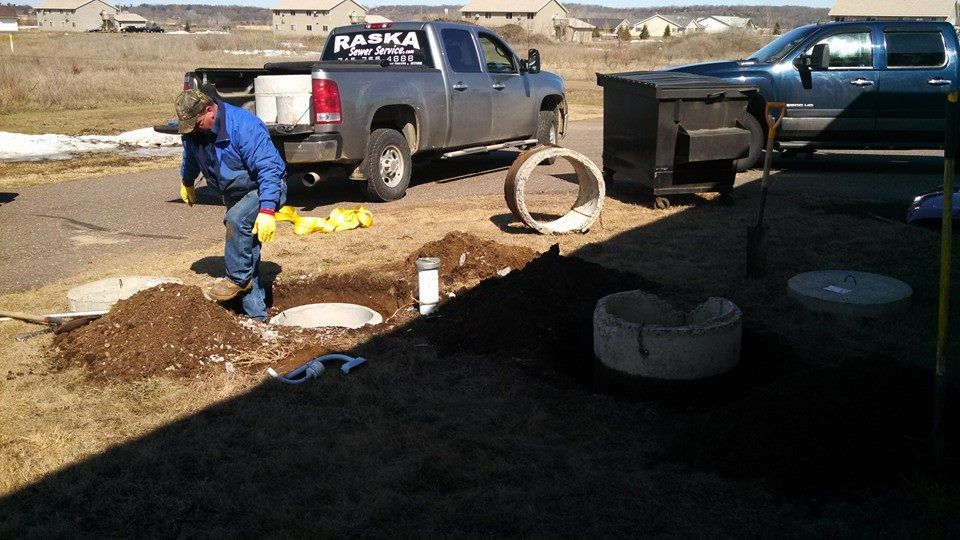 a man installing septic tank underground
