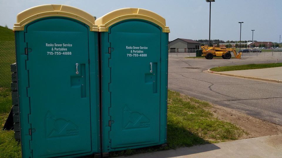 teal portable toilets for a construction area