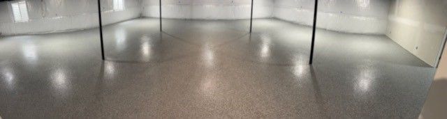 Empty, modern dance studio with mirrored walls and a shiny floor.