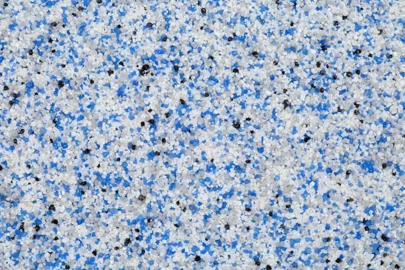 Blue, white, and black speckled surface, resembling a textured, speckled coating.